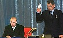 Vladimir Putin at the founding congress of Yedinstvo I Otechestvo (Unity and Motherland) Party with the party\'s co-chairman Sergei Shoigu.