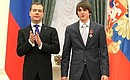 Dmitry Medvedev presents the Order of Courage to Mussa Susurkiyev, a student at Ingush State University.
