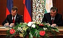 With President of Tajikistan Emomali Rahmon. Signing bilateral documents.