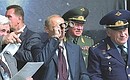 President Putin, Yury Koptev, General Director of the Russian Aerospace Agency (left), and Air Force Commander-in-Chief Vladimir Mikhailov watching demonstration flights at the sixth MAKS-2003 International Aerospace Show.