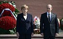 Vladimir Putin and Federal Chancellor of Germany Angela Merkel laid wreaths at the Tomb of the Unknown Soldier in the Alexander Garden.