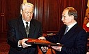 President Boris Yeltsin handing over the “presidential” copy of the Russian constitution to Vladimir Putin.