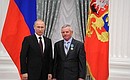 Presenting Russian Federation state decorations. The Order of Friendship is awarded to Saltykovo agricultural production cooperative machine operator Viktor Beznogov.