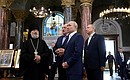Vladimir Putin and Alexander Lukashenko visit the Stavropegial Naval Cathedral of St Nicholas. With Governor of St Petersburg Alexander Beglov (right) and abbot of the cathedral, Archimandrite Alexei. Photo: Alexander Demianchuk, TASS