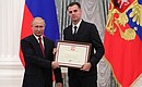 A letter of recognition for contribution to the development of Russian football and high athletic achievements is presented to manager of the Russia national football team Yevgeny Savin.