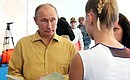 Vladimir Putin familiarizes himself with the projects of the participants at the Seliger 2013 Civil Youth Forum.