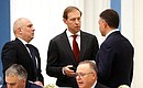 Prior to a meeting with heads of defence industry enterprises. Left to right: Deputy Minister of Industry and Trade Oleg Ryazantsev, Deputy Prime Minister – Minister of Industry and Trade Denis Manturov, and United Aircraft Corporation Director General Yury Slyusar. Photo: Konstantin Zavrazhin