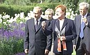 President Putin and his wife Lyudmila with President Tarja Halonen and her husband, Dr Pentti Arajarvi, taking a stroll at the Kultaranta residence.