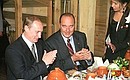 President Vladimir Putin dining with French President Jacques Chirac at the Russkaya Rybalka restaurant.