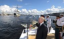 Main Naval Parade. The President having made his rounds of the parade line of Russia’s military ships along the Neva River saluted and congratulated the ships’ crews on Russia Navy Day.
