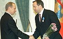 President Putin presenting the Order of Honour to Andrei Kazmin, board chairman of Sberbank, at a decoration ceremony in the Kremlin.