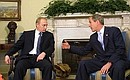 C. President Vladimir Putin and US President George W. Bush talking in the Oval Office.