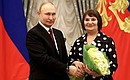 Ceremony for presenting state decorations. The title Honoured Agricultural Worker of the Russian Federation was awarded to milking machine operator at Rechnoye farm Olga Tambovtseva. Photo: Valery Sharifulin, TASS