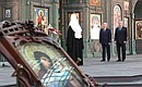 During the visit to the Russian Orthodox Cathedral in honour of the Resurrection of Christ, the Main Cathedral of the Russian Armed Forces. With Defence Minister Sergei Shoigu and Patriarch Kirill of Moscow and All Russia.