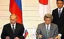 At a ceremony of signing Russian-Japanese documents. President Vladimir Putin and Japanese Prime Minister Junichiro Koizumi are signing the Russian-Japanese Action Programme for Cooperation in the Struggle Against Terrorism.
