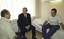 President Putin at a hospital with Major Alexander Dmitriyev and Captain Ramazan Taglanov, two police officers wounded in a special operation and awarded the Medal for Bravery.