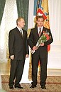 President Vladimir Putin conferring state awards on a group of Russian journalists. Alexander Khabarov, special correspondent of the NTV national television information department, receives the Order of Service to the Fatherland, 1st class.