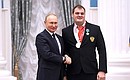 Presenting state decorations to winners of the 2020 Summer Paralympic Games in Tokyo. Paralympic athletics champion Vladimir Sviridov receives the Order of Friendship. Photo: RIA Novosti