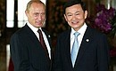Thailand’s Prime Minister, Thaksin Shinawatra, greets guests at the APEC summit
