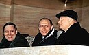 Acting President Vladimir Putin, First Deputy Prime Minister and Finance Minister Mikhail Kasyanov (left) and Moscow Mayor Yuri Luzhkov watching a football match between Spartak Moscow and Alania Vladikavkaz.