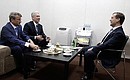 С председателем правления Сбербанка России Германом Грефом и мэром Москвы Сергеем Собяниным.