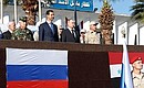 Во время посещения авиабазы Хмеймим в Сирии. С Президентом Сирии Башаром Асадом (слева) и Министром обороны России Сергеем Шойгу (справа).