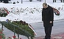 President Putin laying a wreath at the Piskarevsky Cemetery memorial.