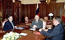 President Vladimir Putin with Information Technology and Communications Minister Leonid Reiman and Press, Television and Radio Broadcasting and Mass Media Minister Mikhail Lesin.