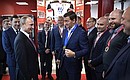 During his visit to the Datsyuk Arena sports complex, Vladimir Putin meets with the players of the team Neoplan, winners of the 2014 Night Hockey League tournament.