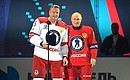 Vladimir Putin presents a special prize to amateur hockey player Oleg Smirnov.