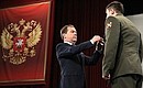 Dmitry Medvedev presents the Order of Courage to Alexei Shulga.