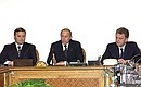 President Putin, centre, meeting with members of the outgoing government. With the president are Mikhail Kasyanov, left, and Acting Prime Minister Viktor Khristenko, right.