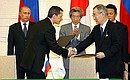 At a ceremony of signing Russian-Japanese documents. At presence of Vladimir Putin and Japanese Prime Minister Junichiro Koizumi Russian Deputy Trade and Economic Development Minister Andrei Sharonov and Japanese Ambassador to the Russian Federation Issei Nomura are signing Report on Concluding Talks on Goods and Services Within the Framework of Russia\'s Accession to the WTO.