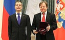 Dmitry Medvedev presents the certificate conferring the honorary title National Artist of Honour to saxophonist and musician Igor Butman.