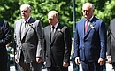 Following the parade, Vladimir Putin and heads of foreign states laid flowers at the Tomb of the Unknown Soldier in Alexander Garden to commemorate those killed in the Great Patriotic War. With President of Abkhazia Aslan Bzhania, left, and President of Moldova Igor Dodon.