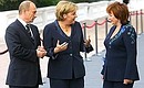 With Lyudmila Putina and German Chancellor Angela Merkel before the start of an informal lunch for the G8 heads of state and government and their spouses.