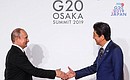 С Премьер-министром Японии Синдзо Абэ перед началом первого рабочего заседания саммита «Группы двадцати». Фото: Михаил Метцель, ТАСС