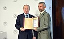 Meeting of the Russian Geographical Society Board of Trustees. Vladimir Putin presented a grant certificate for a project to create a cave database to Gennady Samokhin, learned secretary of the Russian Geographical Society division in the Republic of Crimea.