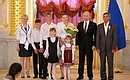 Presenting the Order of Parental Glory to Nina and Alexander Savelyev, who are raising 12 children.