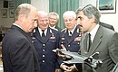 President Putin visiting the Sukhoi Aviation Military Industrial Complex. Mikhail Pogosyan, CEO of the complex, presenting a fighter model to President Putin.