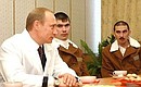 President Putin with soldiers being treated at the Burdenko military hospital.