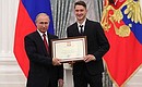 A letter of recognition for contribution to the development of Russia football and high athletic achievement is presented to Russia national football team player Alexei Miranchuk.