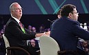 CEO of the Russian Direct Investment Fund Kirill Dmitriev (left) at the plenary session of the Artificial Intelligence Journey conference.