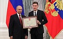 A letter of recognition for contribution to the development of Russia football and high athletic achievement is presented to Russia national football team player Daler Kuzyayev.