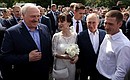 Vladimir Putin and Alexander Lukashenko talk with people who gathered in the square in front of the Stavropegial Naval Cathedral of St Nicholas. Photo: Alexander Demianchuk, TASS
