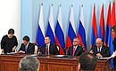 Signing documents following Russian-Armenian talks.
