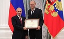 A letter of recognition for contribution to the development of Russia football and high athletic achievements is presented to Russia national football team coach Miroslav Romashchenko.