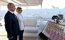 Vladimir Putin took part in a ceremony of raising the flags of the Russian Federation, the USSR and the Russian Empire on the coast of the Gulf of Finland. With Yelena Ilyukhina, Deputy General Director of Gazprom Neft and General Director of Gazprom Lakhta. Photo: Pavel Lisitsyn, RIA Novosti