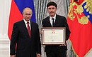 A letter of recognition for contribution to the development of Russia football and high athletic achievement is presented to Russia national football team player Yury Zhirkov.