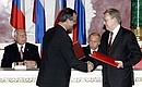 During the signature of bilateral agreements following talks with Czech President Vaclav Klaus (in the background).